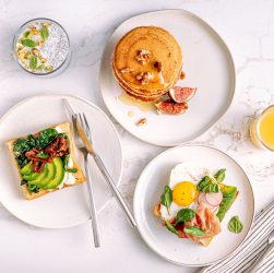 Aerial view of a delicious and healthy breakfast with pancakes, avocado toast, and refreshing drinks. — Bulk discounts availa