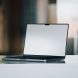 A sleek, modern laptop positioned on a desk with a blurred background.