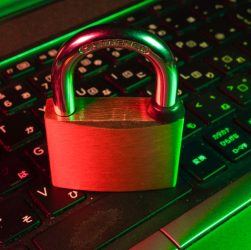 A locked padlock resting on a laptop keyboard, symbolizing security and account management.