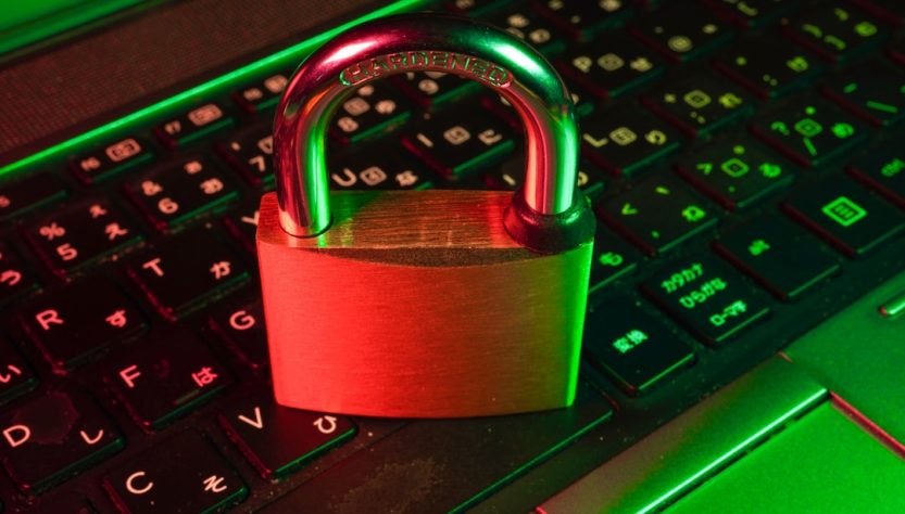 A locked padlock resting on a laptop keyboard, symbolizing security and account management.